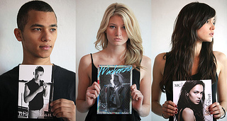 Models holding up their comp cards