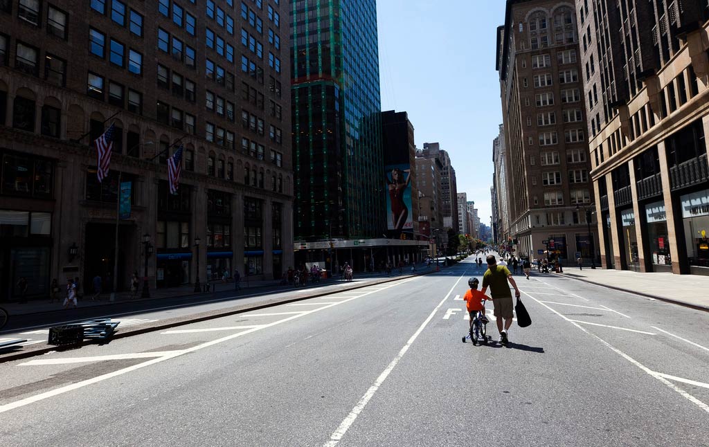 Dad teaching son how to bike on Park Ave.